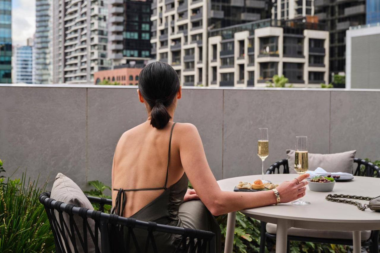 Melbourne Marriott Hotel Docklands Εξωτερικό φωτογραφία A woman sitting on a balcony